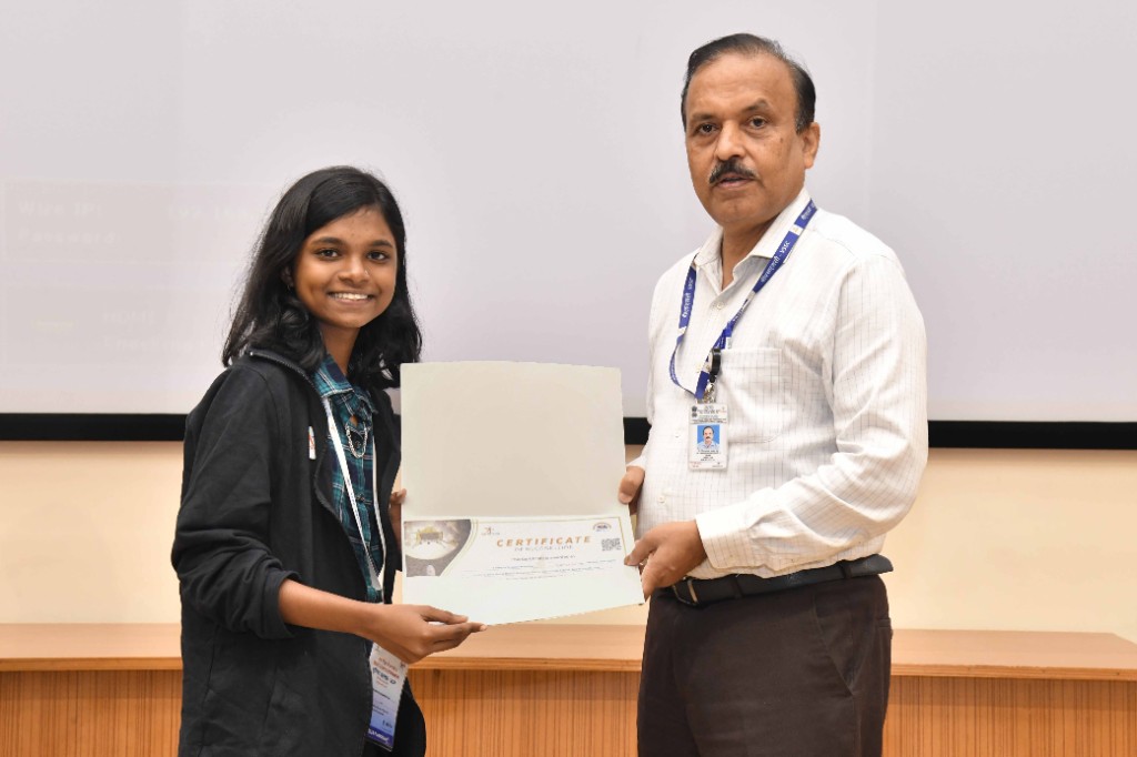 Snehada receiving a certificate